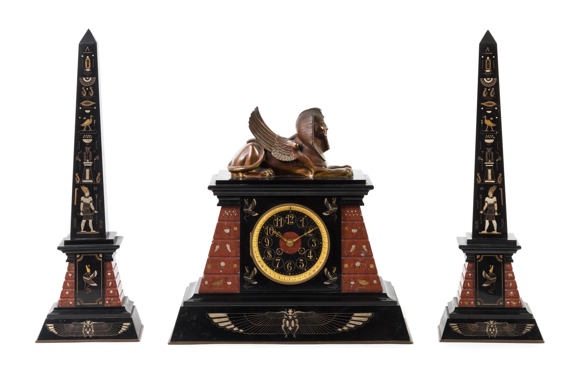 A French Egyptian Revival Three-Piece Clock Garniture Height of obelisk 20 1/4 inches. — 19TH/20TH CENTURY