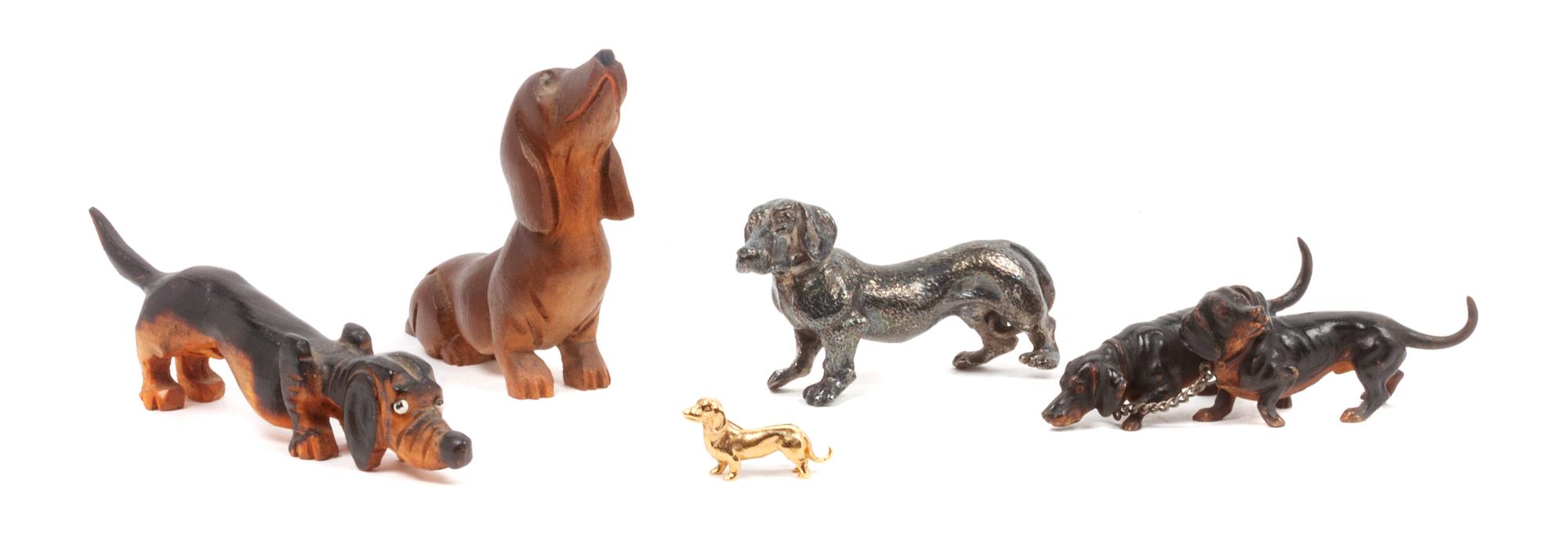 A Group of Four Dachshund Figures Height of tallest 3 1/2 inches.