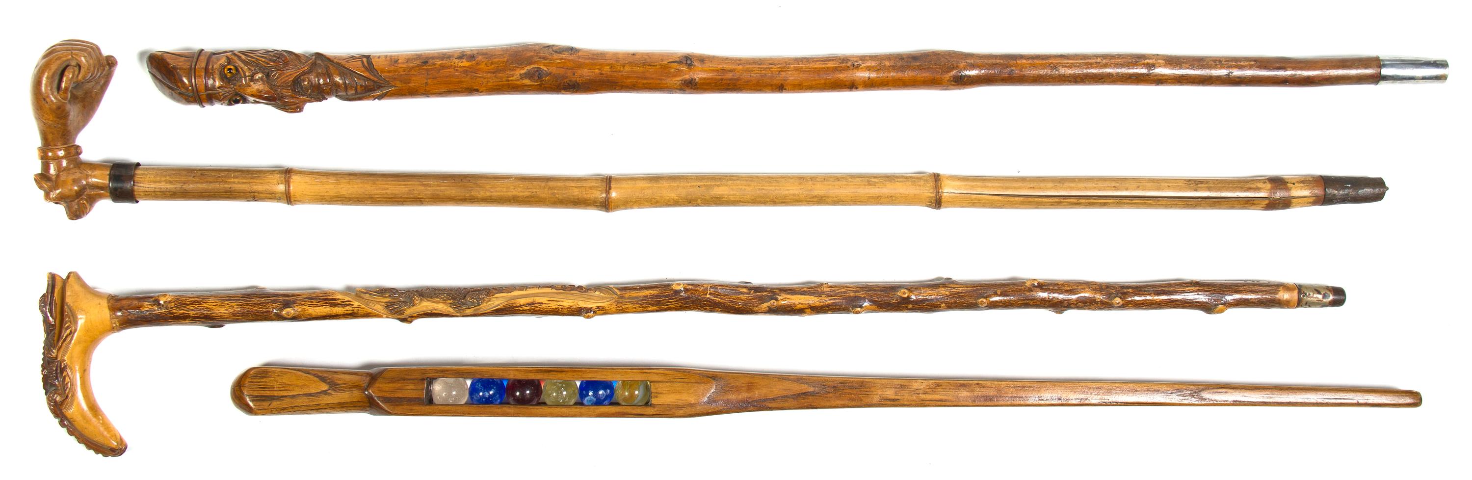 A Collection of Three Carved Wood Canes, Height of tallest overall 37 inches.