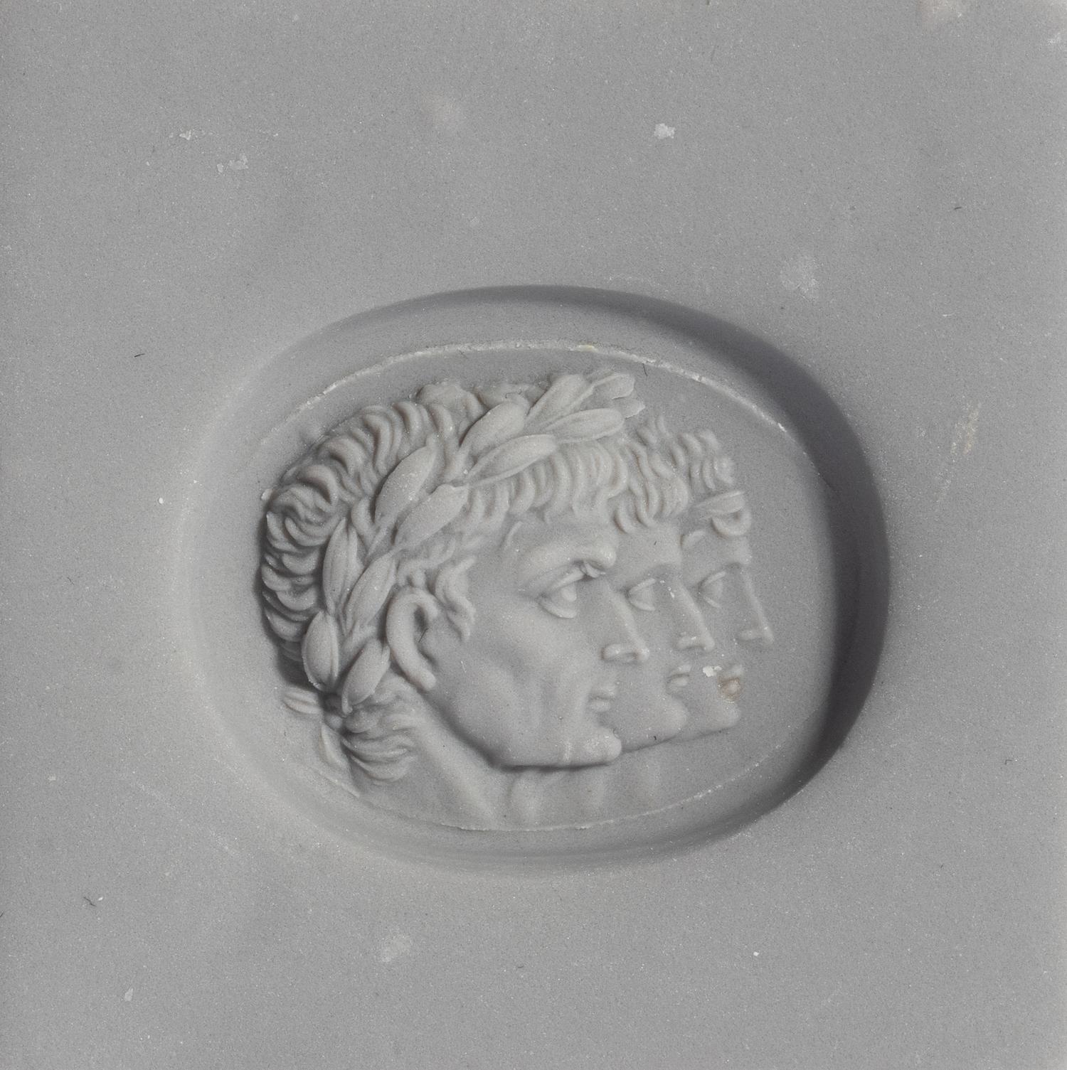 A Neoclassical Carnelian and Gold Finger Ring with a Roman Triumvir