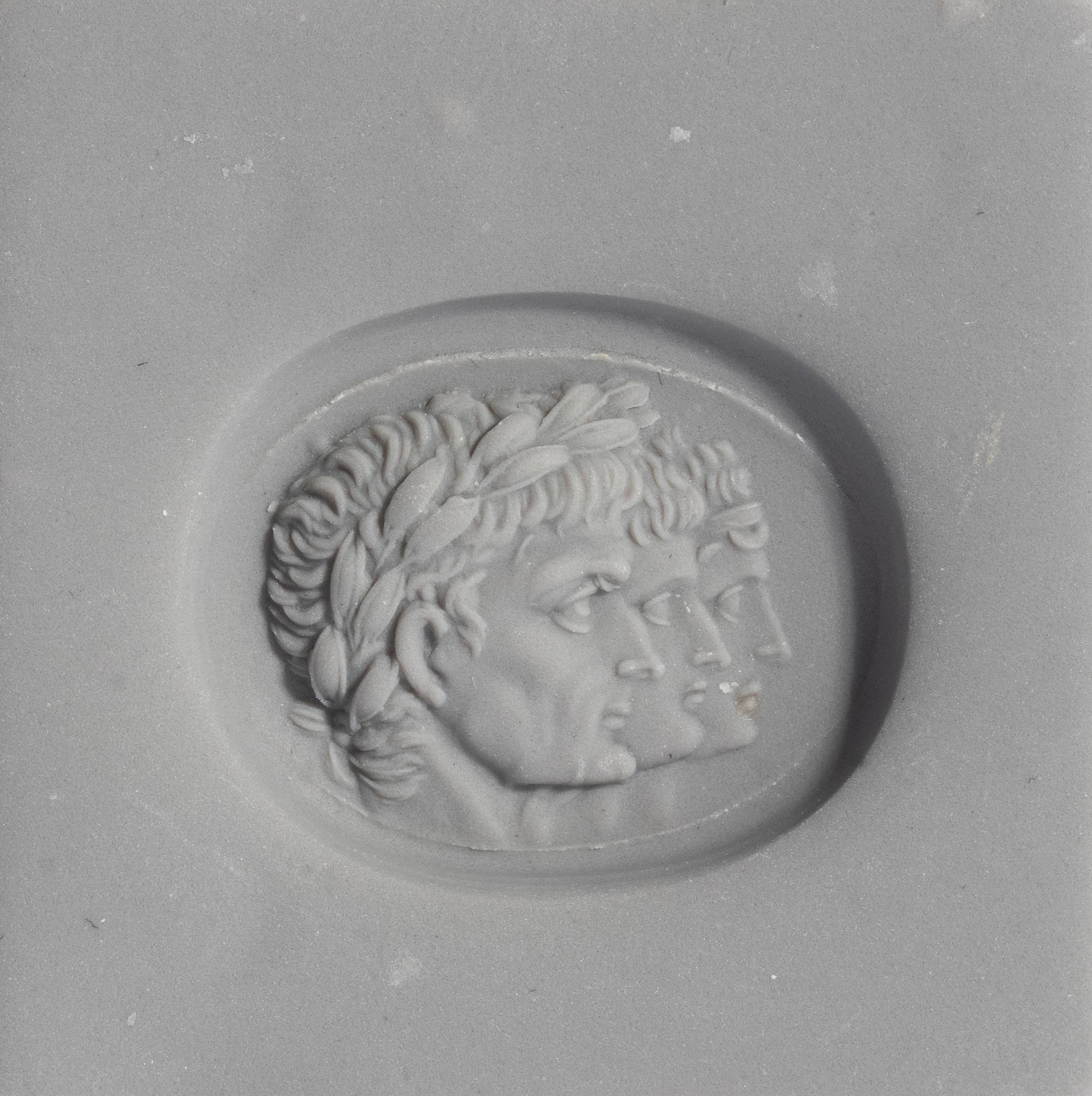 A Neoclassical Carnelian and Gold Finger Ring with a Roman Triumvir
