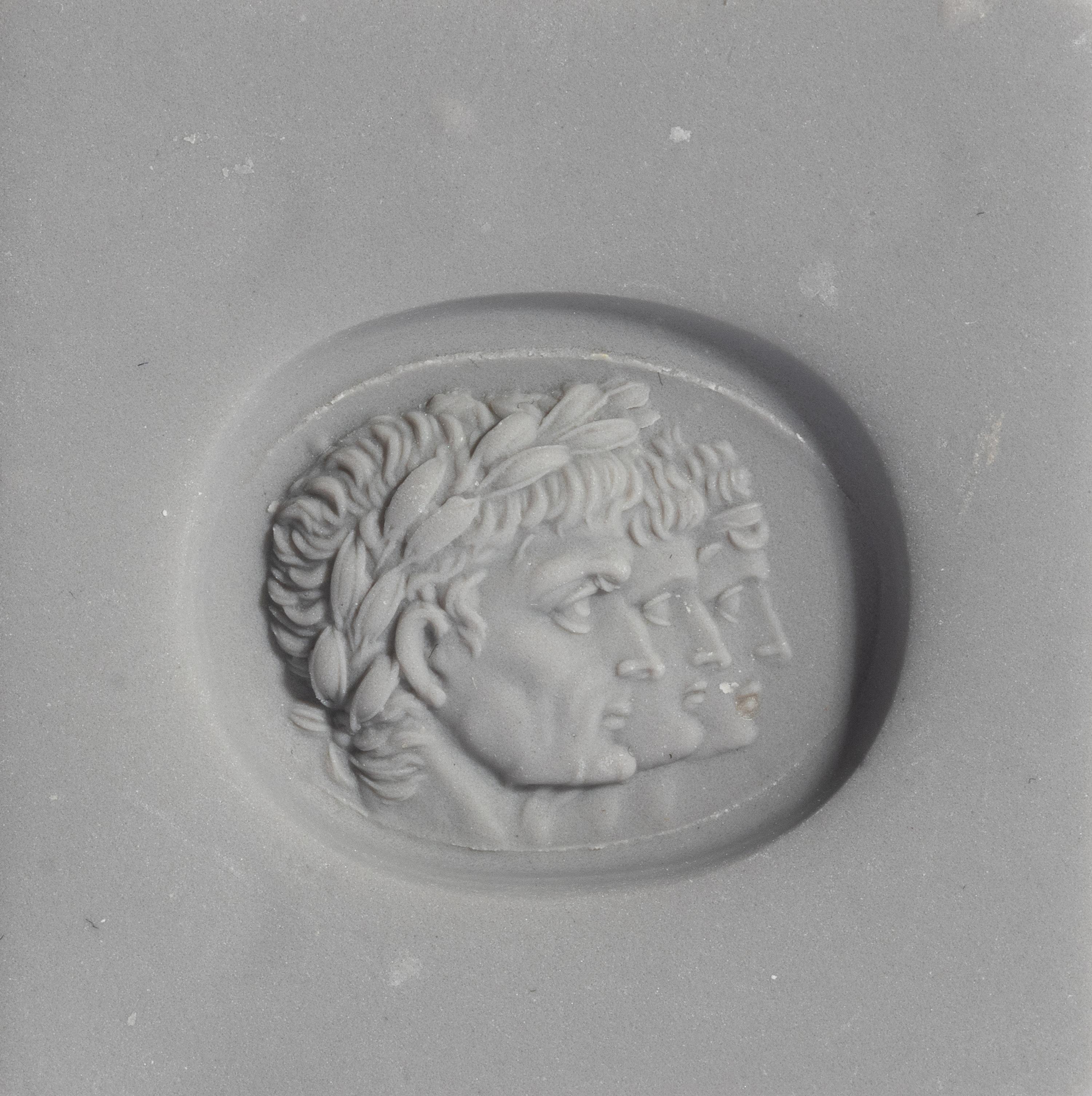 A Neoclassical Carnelian and Gold Finger Ring with a Roman Triumvir