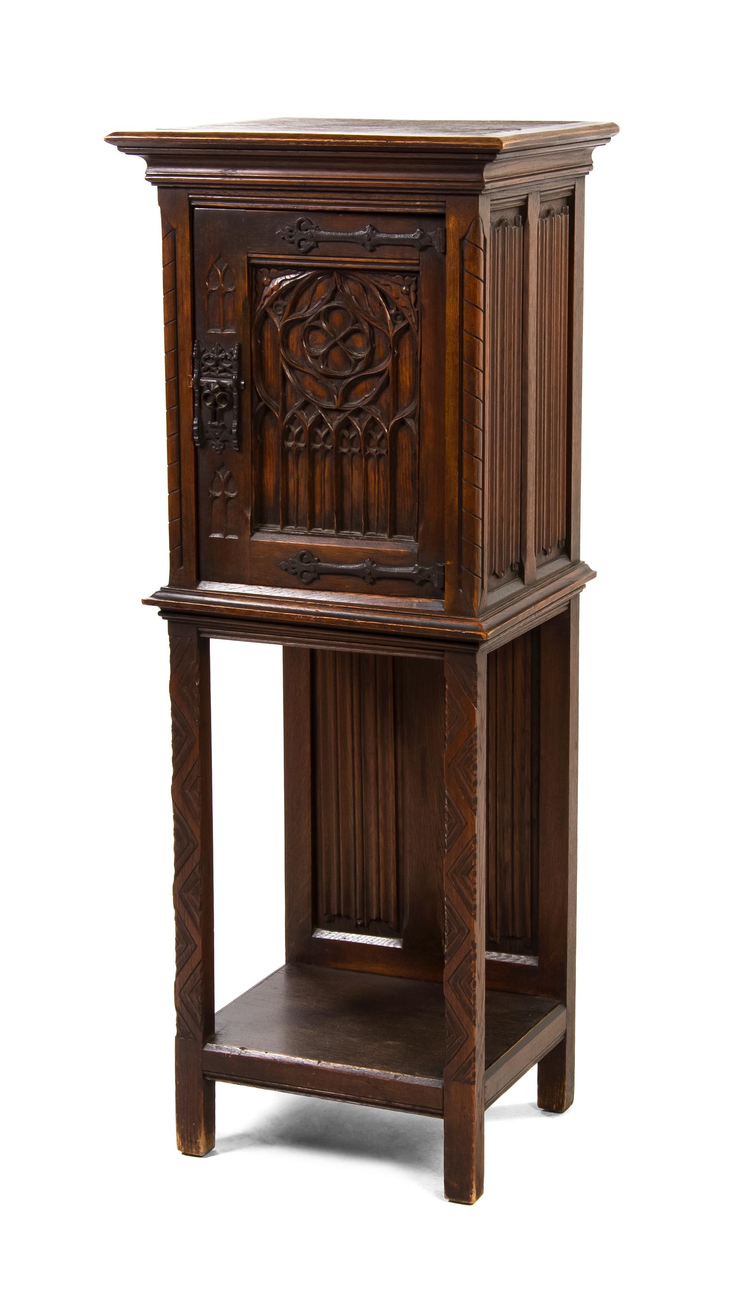 A Continental Gothic Revival Oak Cupboard, Height 50 x width 19 1/2 x depth 14 3/4 inches.