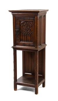 A Continental Gothic Revival Oak Cupboard, Height 50 x width 19 1/2 x depth 14 3/4 inches.