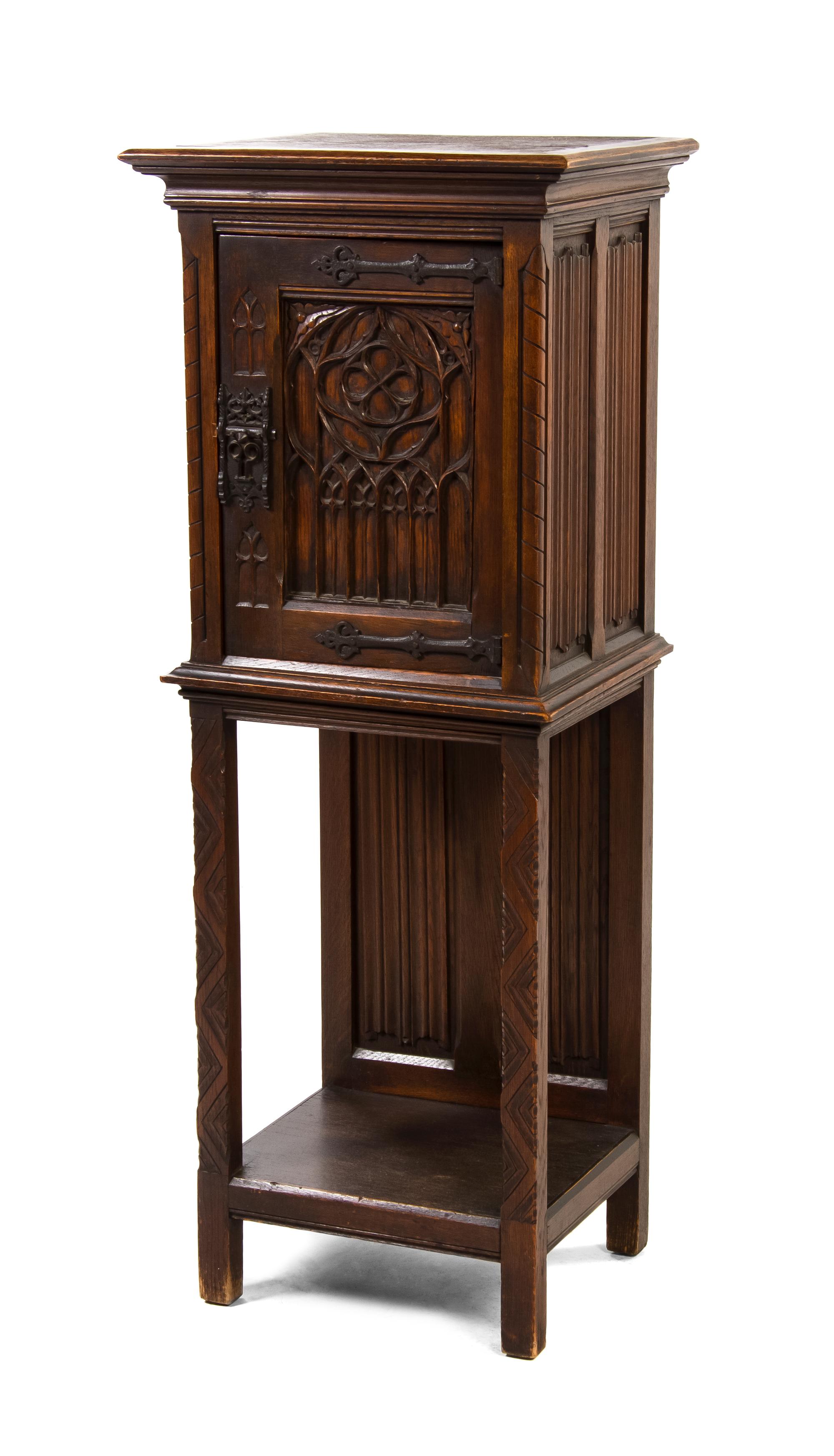 A Continental Gothic Revival Oak Cupboard, Height 50 x width 19 1/2 x depth 14 3/4 inches.