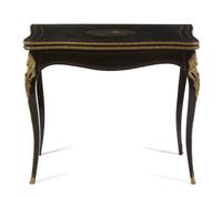 A Napoleon III Ebonized and Gilt Metal Mounted Games Table, Height 29 x width 33 x depth 16 5/8 inches (closed).