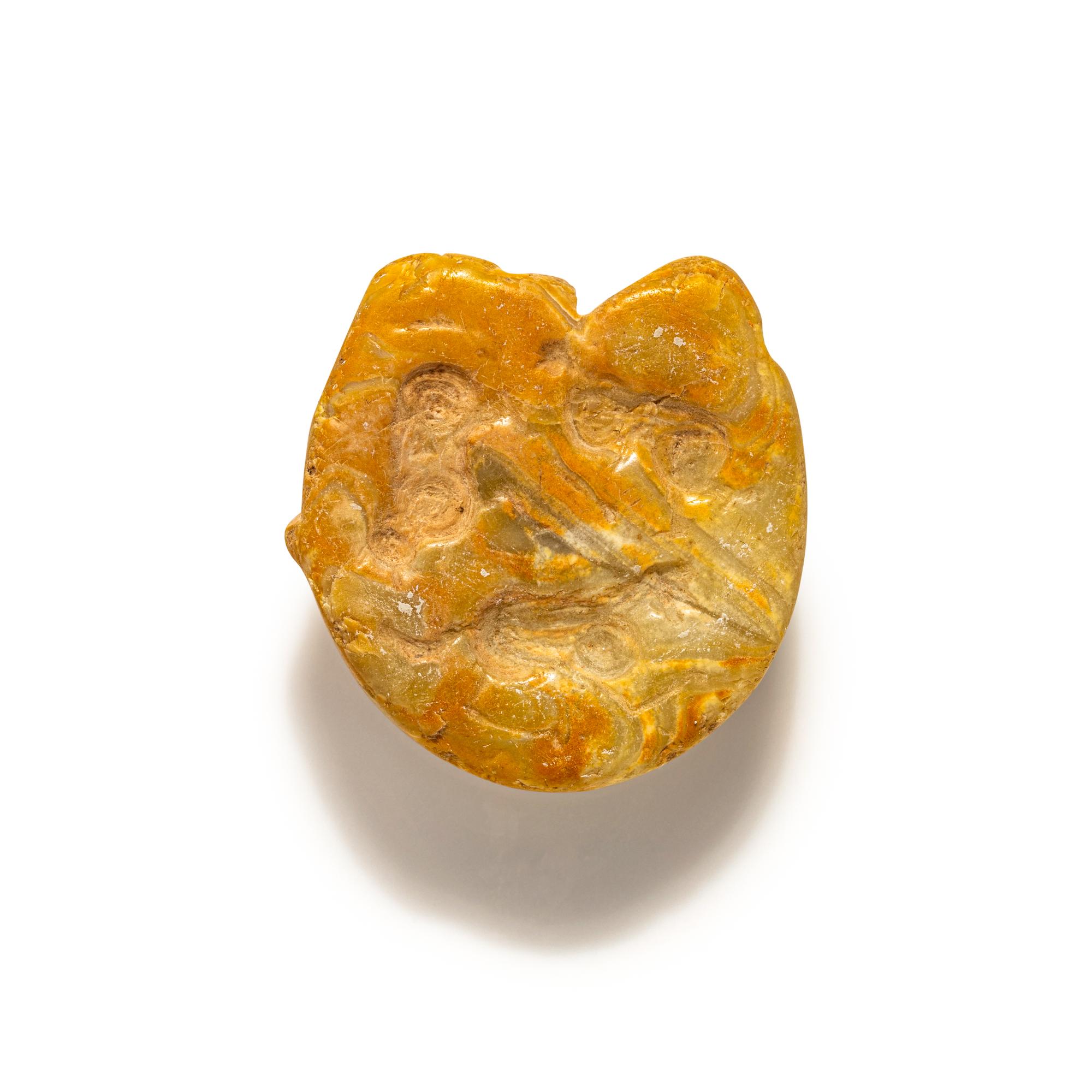 A Mesopotamian Yellow Jasper Stamp Seal with the Head of a Lion