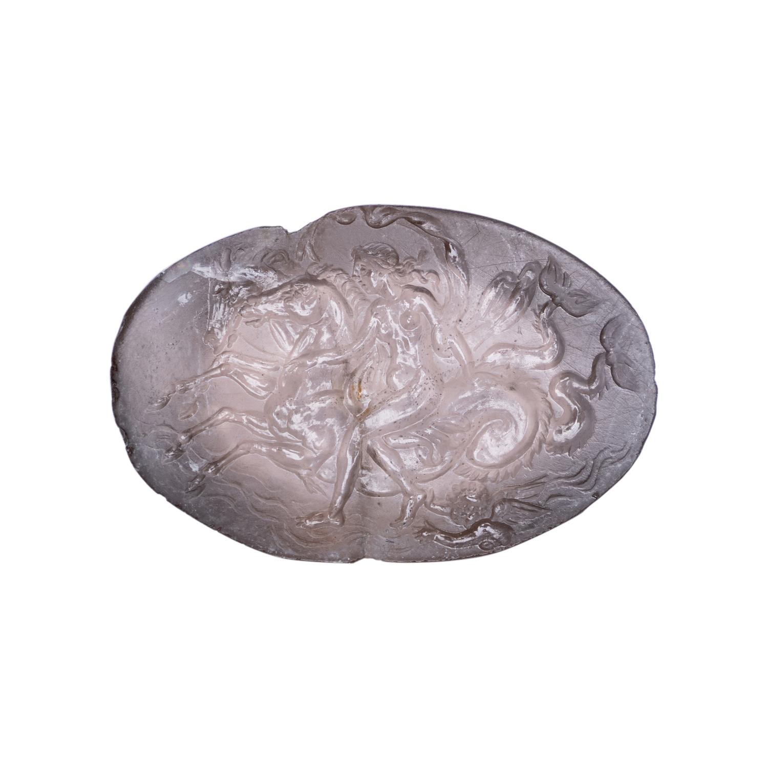 A Roman Smokey Quartz Intaglio with a Nereid Riding Two Hippocamps