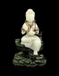 A Pale Celadon and Spinach Jade Figure of Guanyin