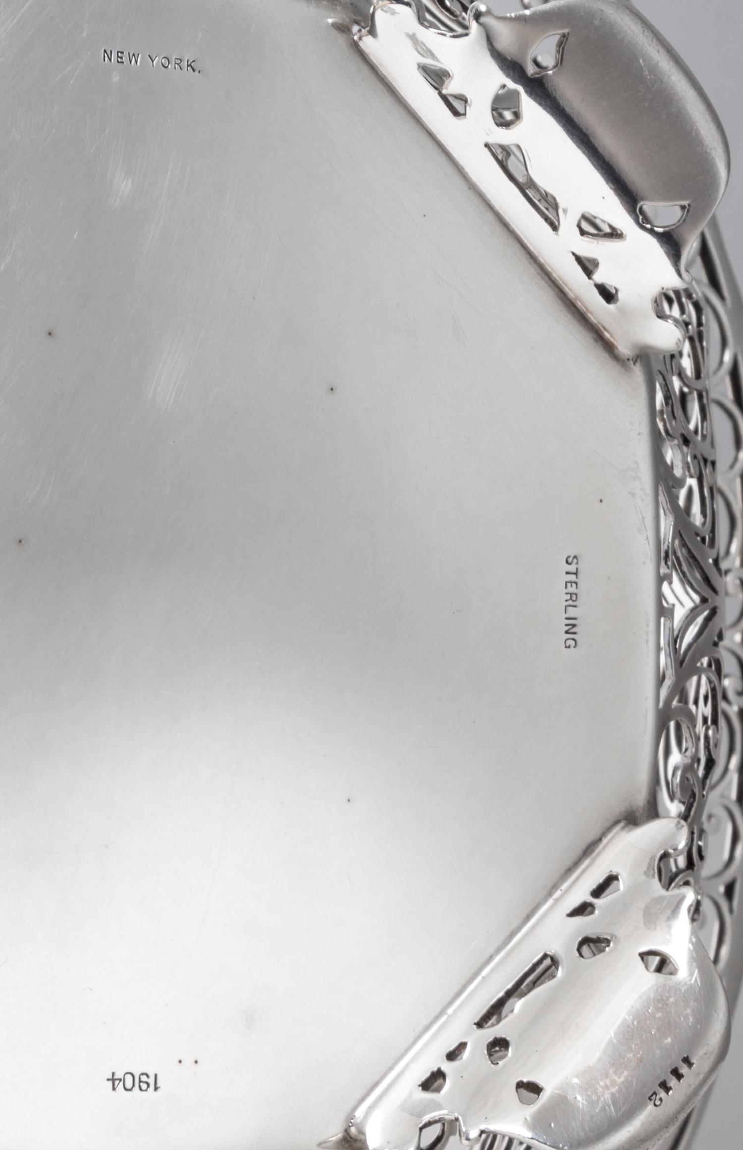 An American Silver Basket, Howard & Co., New York, NY, having a scrolling foliate open bowl with an octagonal bottom, raised on four sh