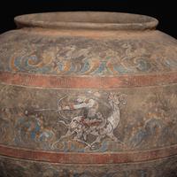 A Chinese Painted Pottery 'Mythical Beast' Jar, Han Dynasty — 漢 灰陶彩繪狩獵圖大罐