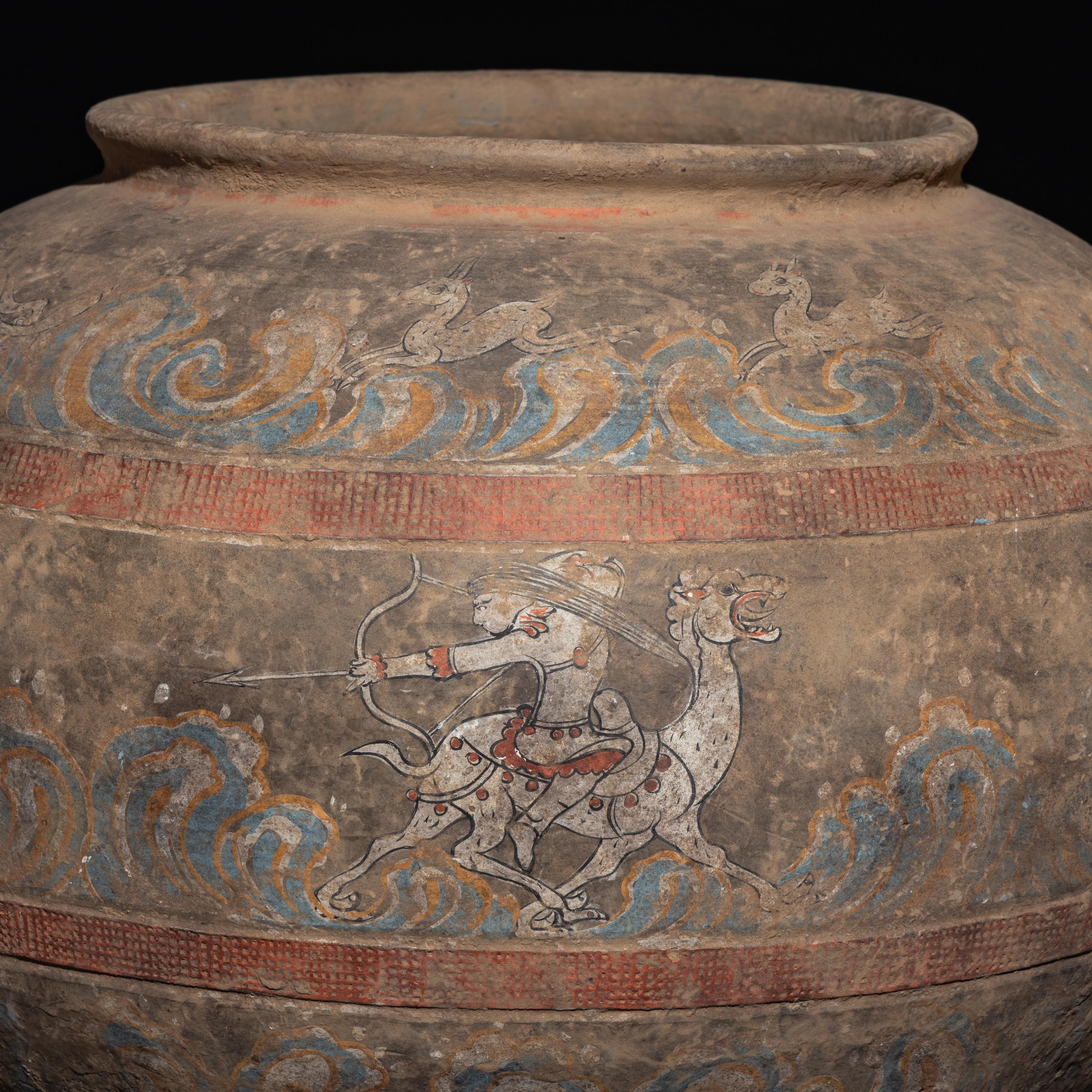 A Chinese Painted Pottery 'Mythical Beast' Jar, Han Dynasty — 漢 灰陶彩繪狩獵圖大罐