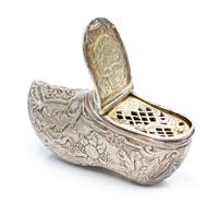 A German Silver Vinaigrette, Maker's Mark Obscured, in the form of a shoe, the exterior chased with floral, foliate and fauna decoratio