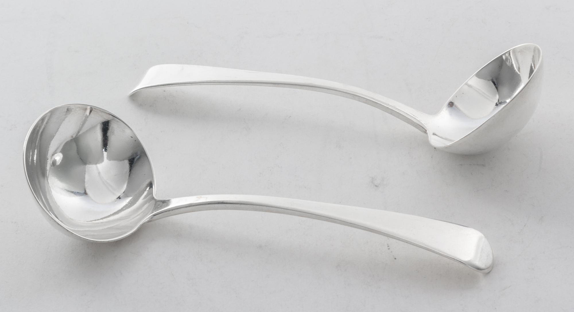 A Pair of English Silver Sauce Ladles, Richard Crossly, London, 1812, with rounded down-turned handles.
