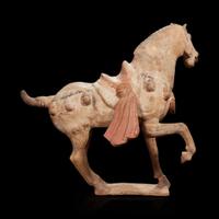 A Chinese painted pottery figure of a prancing horse Tang dynasty