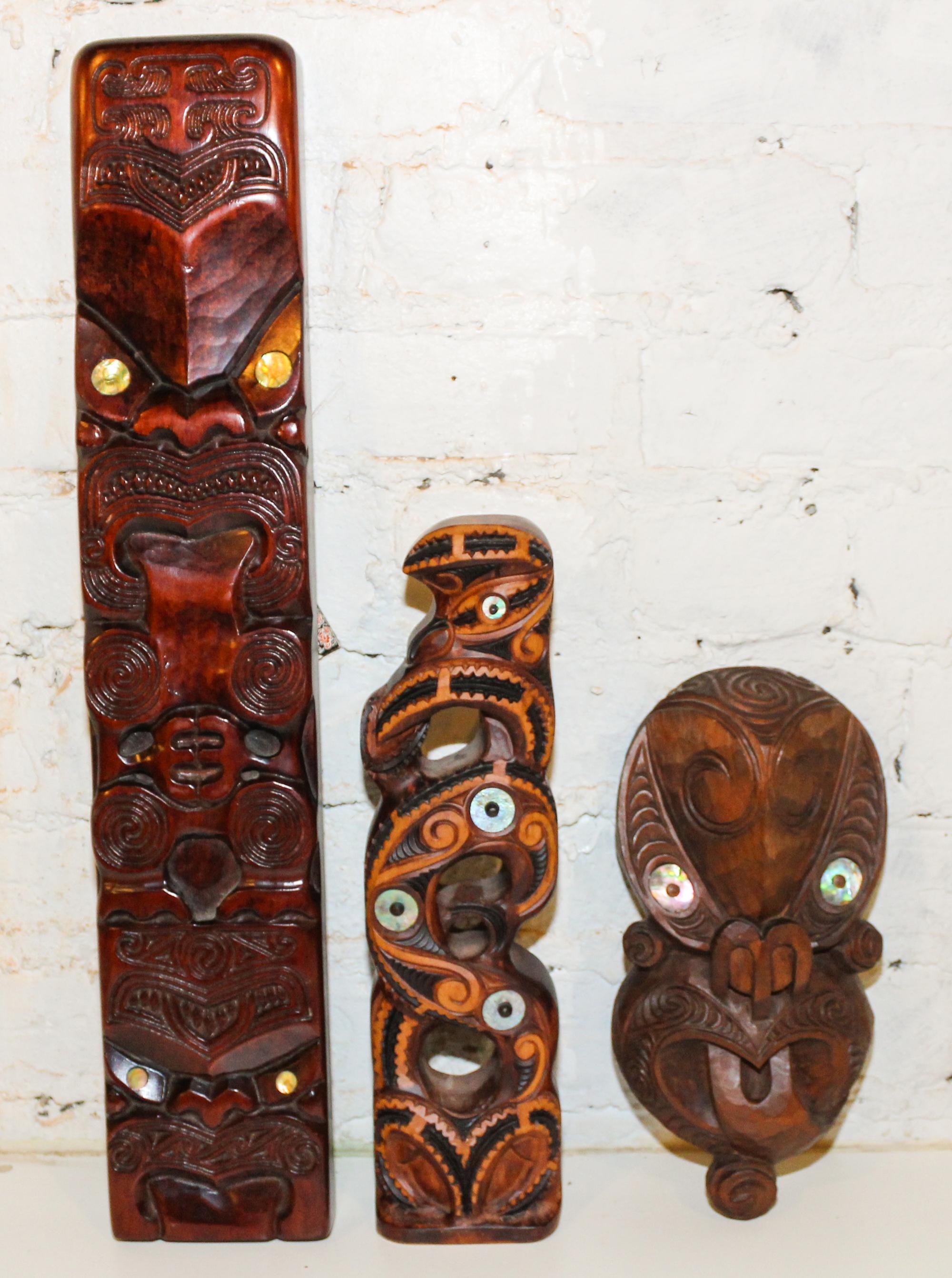 A Group of Three Maori Carved Wood Masks Height of tallest 21 inches.
