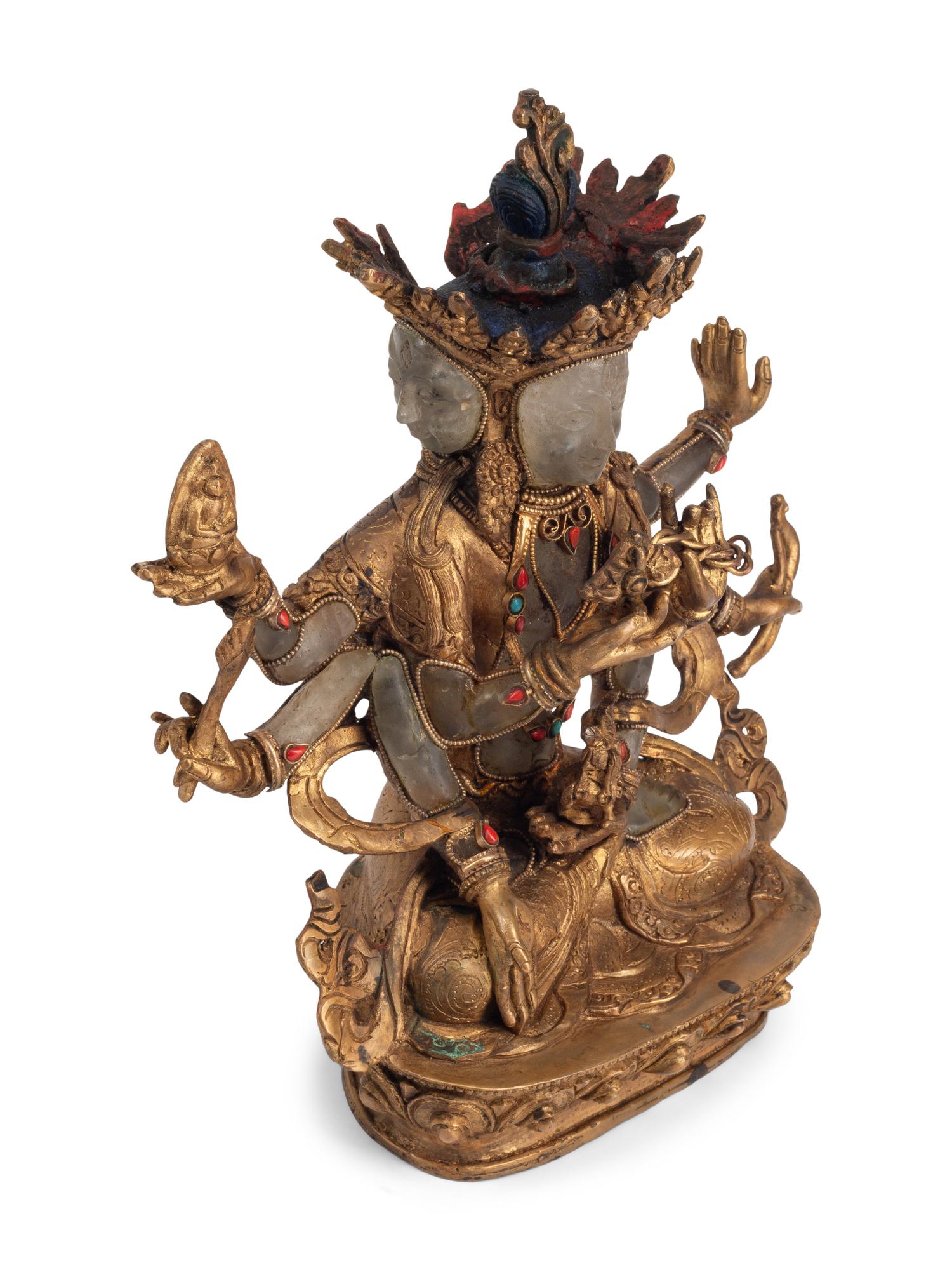 A Tibetan Style Gilt Bronze, Rock Crystal and Cabochon-Inset Figure of a Deity