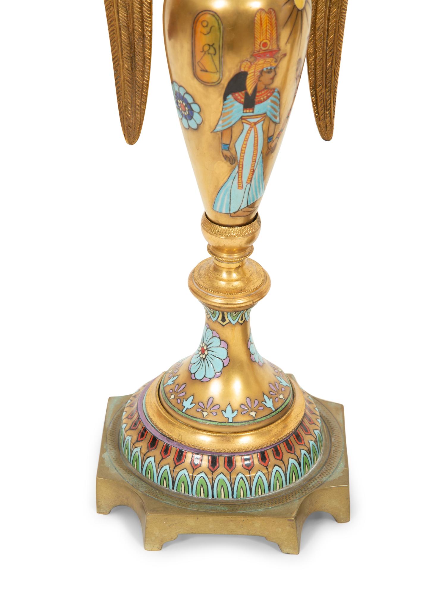 A Pair of Continental Egyptian Revival Porcelain and Gilt Bronze Urn Ornaments