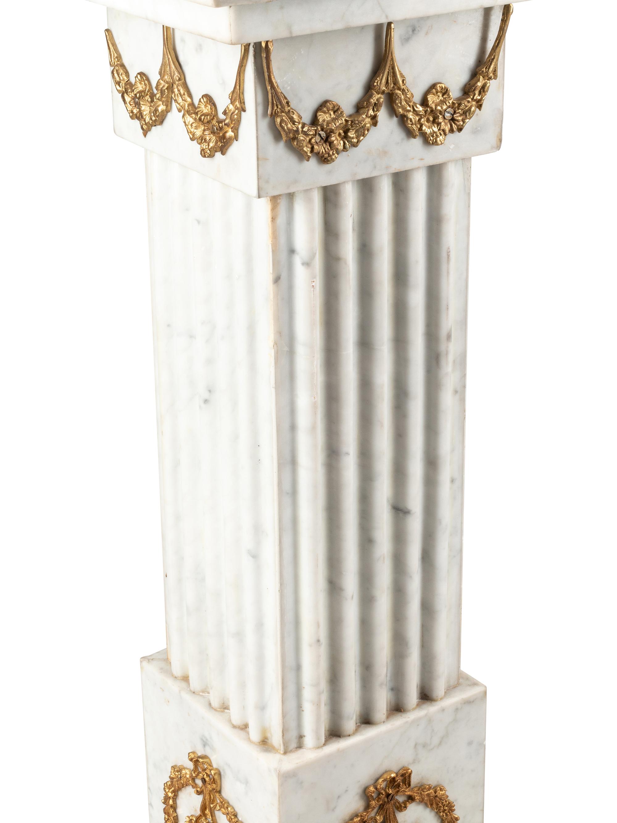 A Pair of Louis XVI Style Gilt Bronze Mounted White Marble Pedestals