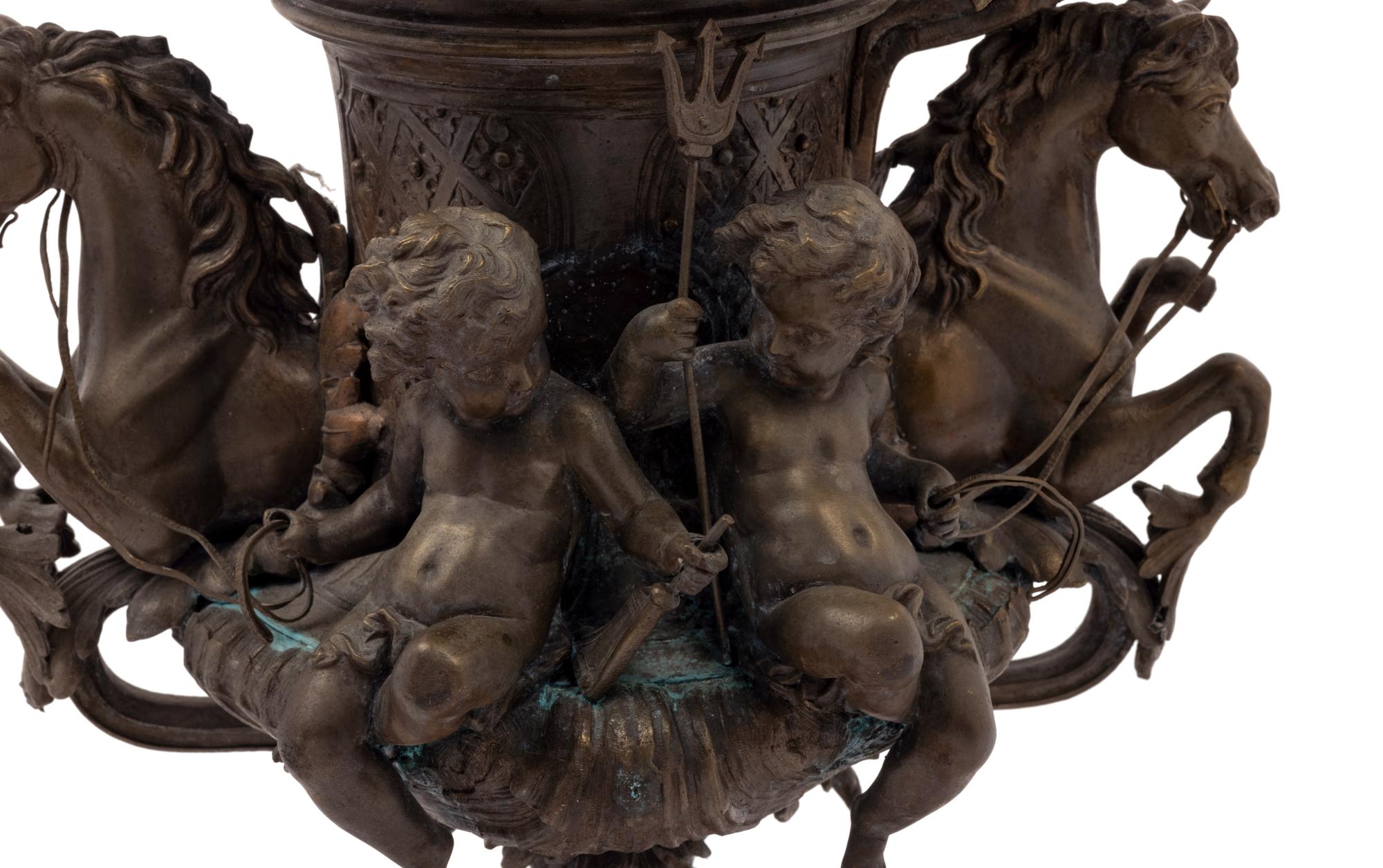 A Continental Cast Metal Urn with Putti and Hippocampi