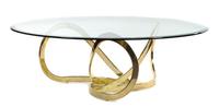 A Brass and Glass Coffee Table Height 15 3/4 x diameter 48 inches. — STYLE OF MILO BAUGHMAN