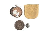 Corporal William L. Miller, Company G, 7th Indiana Volunteers. Bullet-struck pocket watch carried at the Battle of the Wilderness, which saved his life, with original bullet that almost ended it. May 1864.