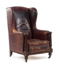 An Italian Leather-Upholstered Wingback Armchair Height 42 x width 27 x depth 32 inches. — CIRCA 1830