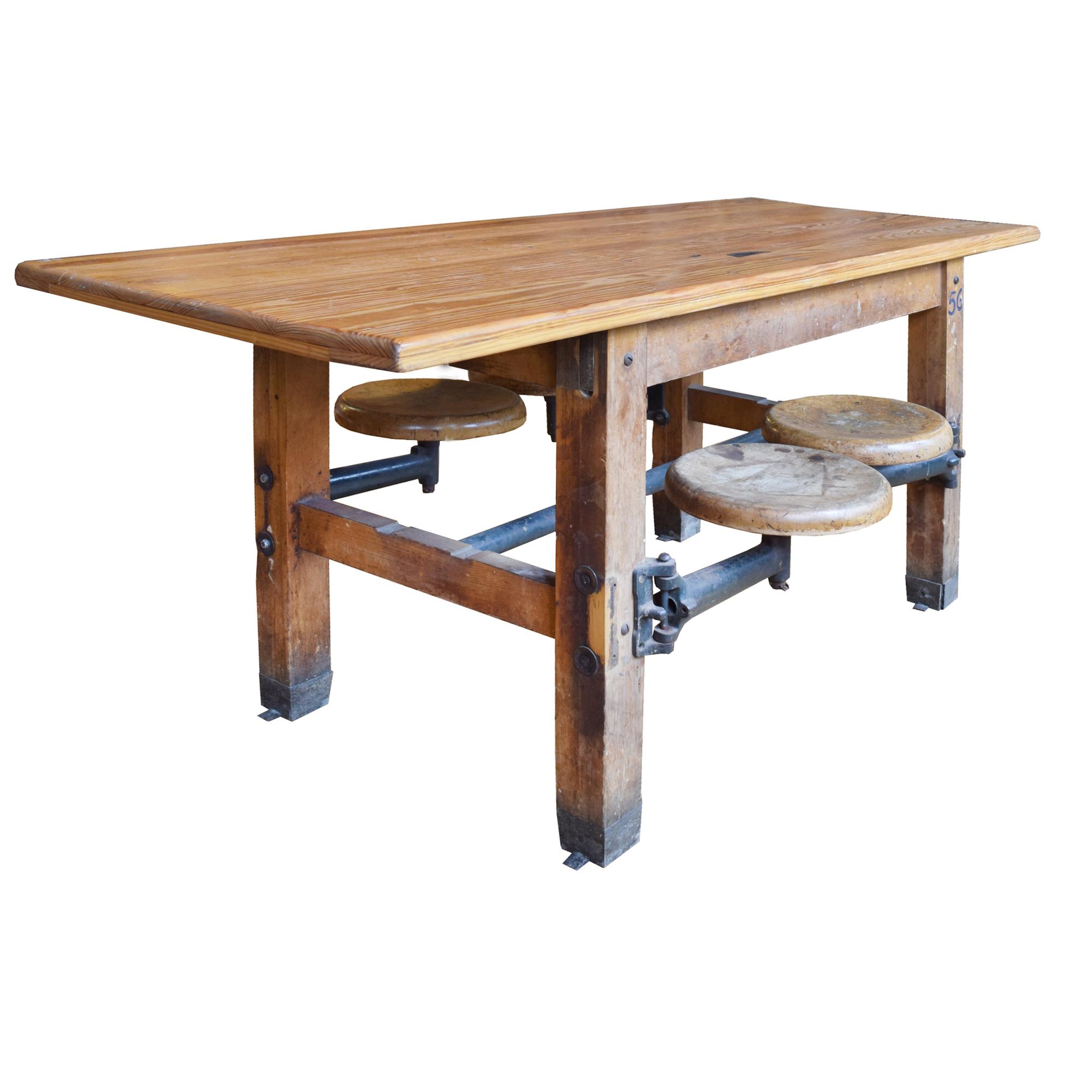 An Industrial Table with Swing Arm Seats 71" W x 29.5" D x 30" H — United States, Circa 1930