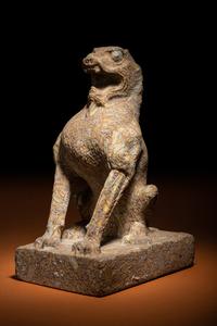 A Carved Puddingstone Figure of a Seated Lion