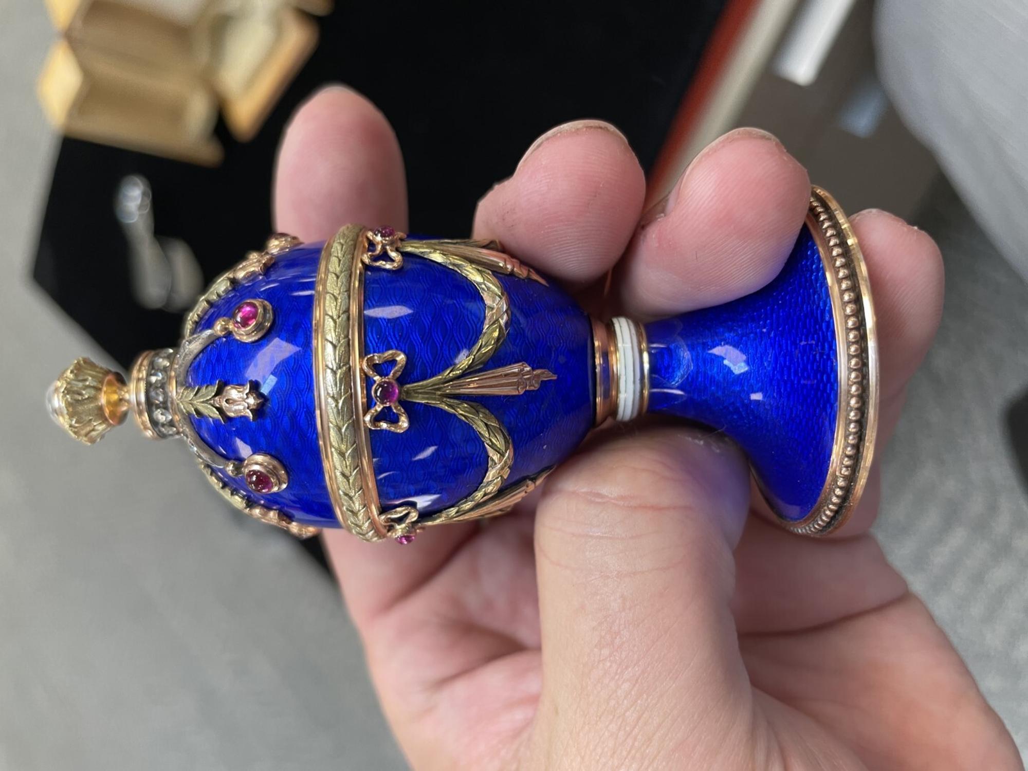 A 14 Karat Vari-Color Gold, Guilloché Enamel, Diamond, and Cabochon Jewel-Mounted Egg-Form Perfume and a Related Guilloché Enamel, 14 Karat Vari-Color Gold, Diamond, and Cabochon-Mounted Surprise Egg