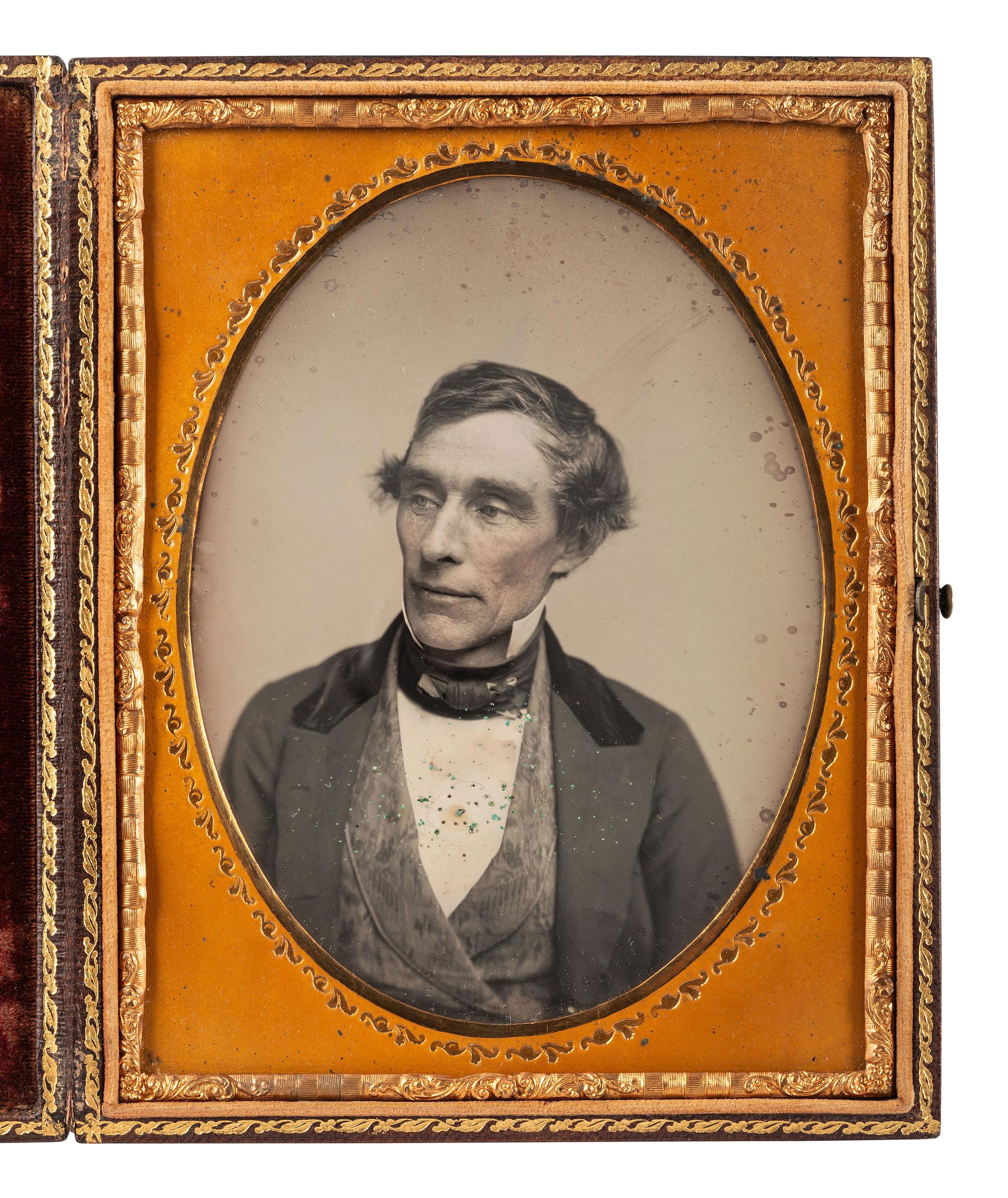[EARLY PHOTOGRAPHY]. 2 daguerreotypes of men in cases bearing British emblems.
