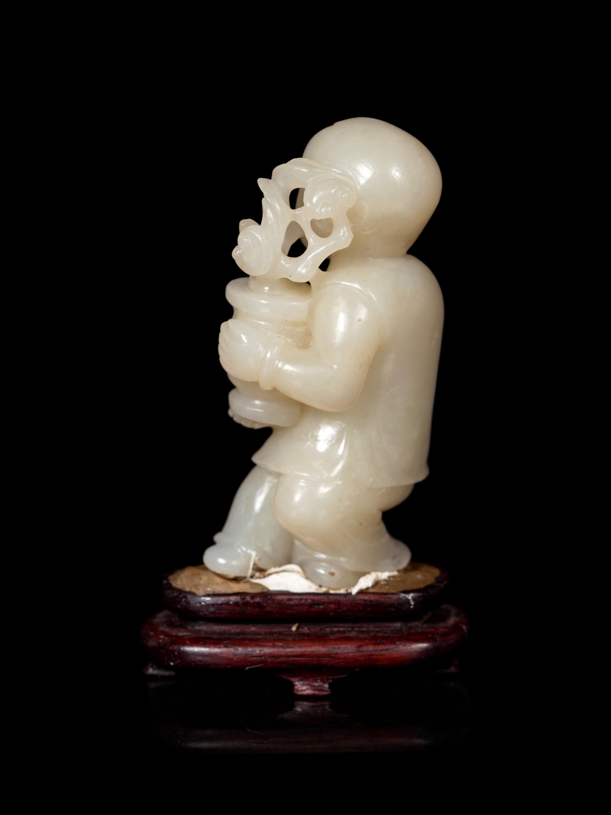 A Chinese Pale Celadon Jade Figure of a Boy