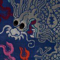A Chinese Blue Ground Brocade 'Dragon' Robe, Jifu, Late Qing Dynasty 清晚期 藍地織錦云龍紋吉服