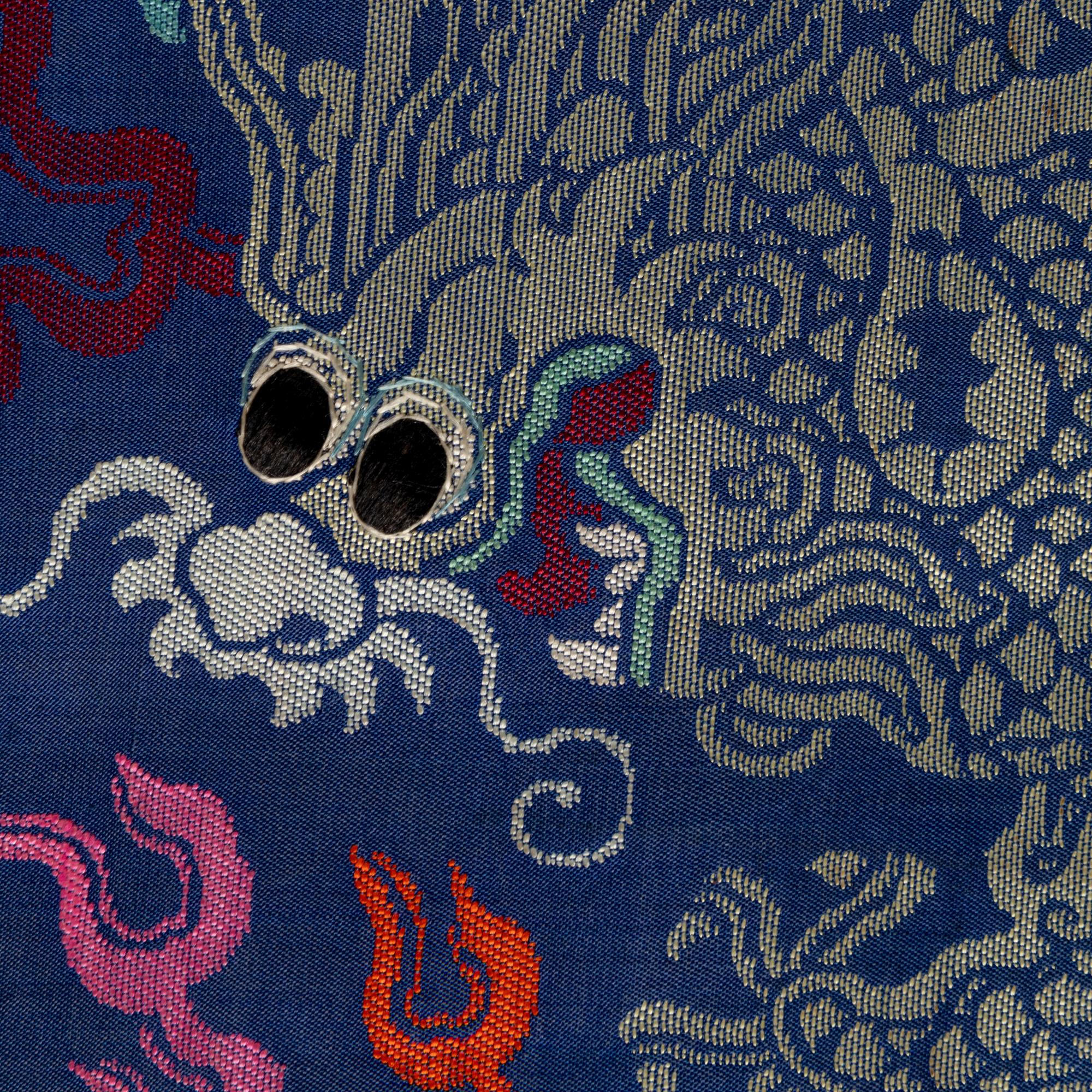 A Chinese Blue Ground Brocade 'Dragon' Robe, Jifu, Late Qing Dynasty 清晚期 藍地織錦云龍紋吉服