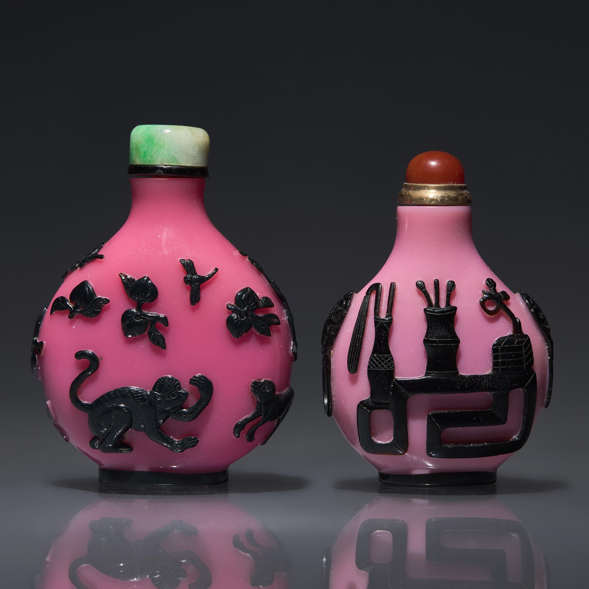 Two Chinese Carved Black-Overlaid Pink Glass Snuff Bottles, Qing Dynasty, Circa 1780-1900 — 1780-1900年 粉紅地套黑料鼻煙壺兩支