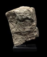An Egyptian Limestone Fragment of a Mother Nursing her Child