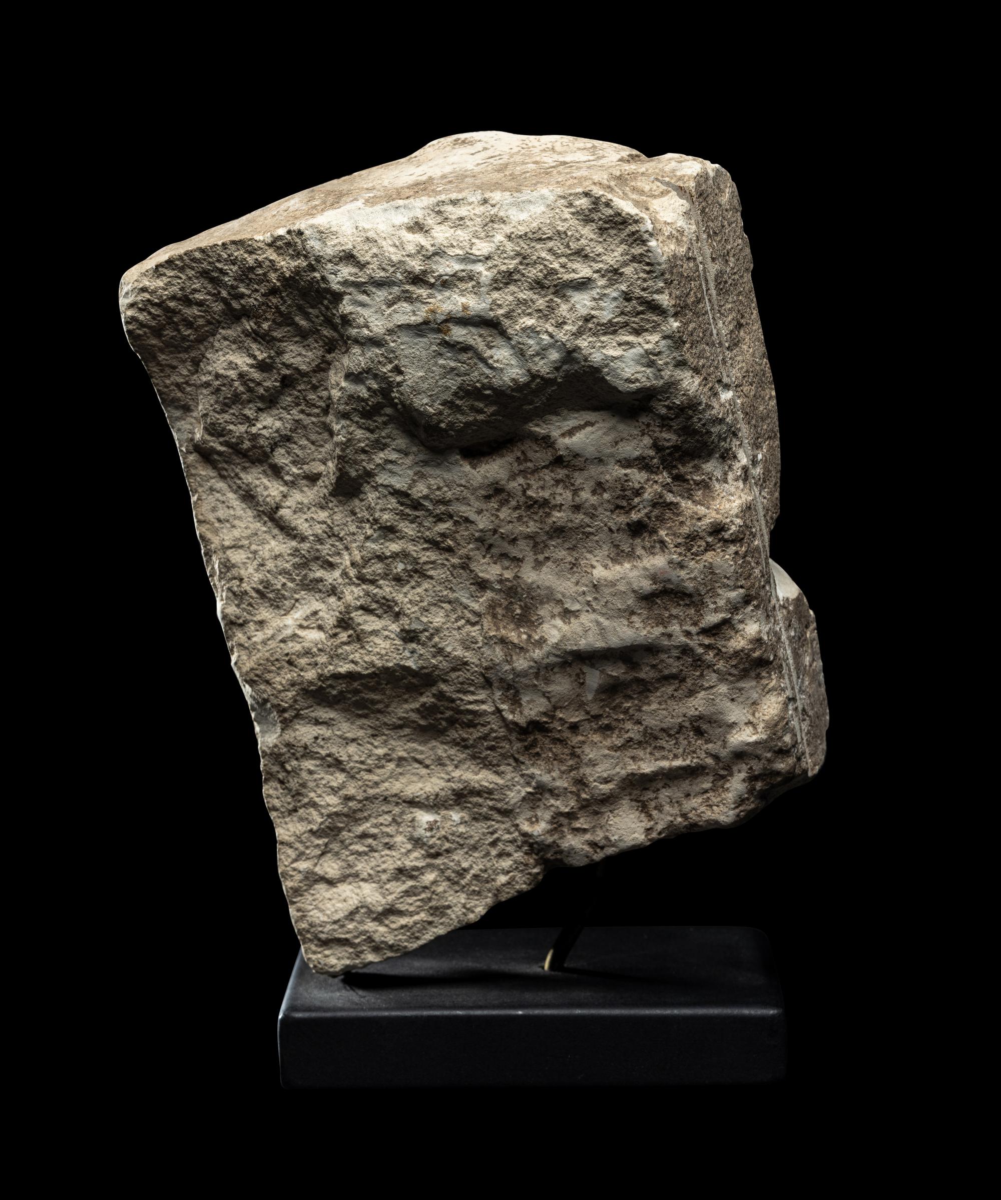 An Egyptian Limestone Fragment of a Mother Nursing her Child