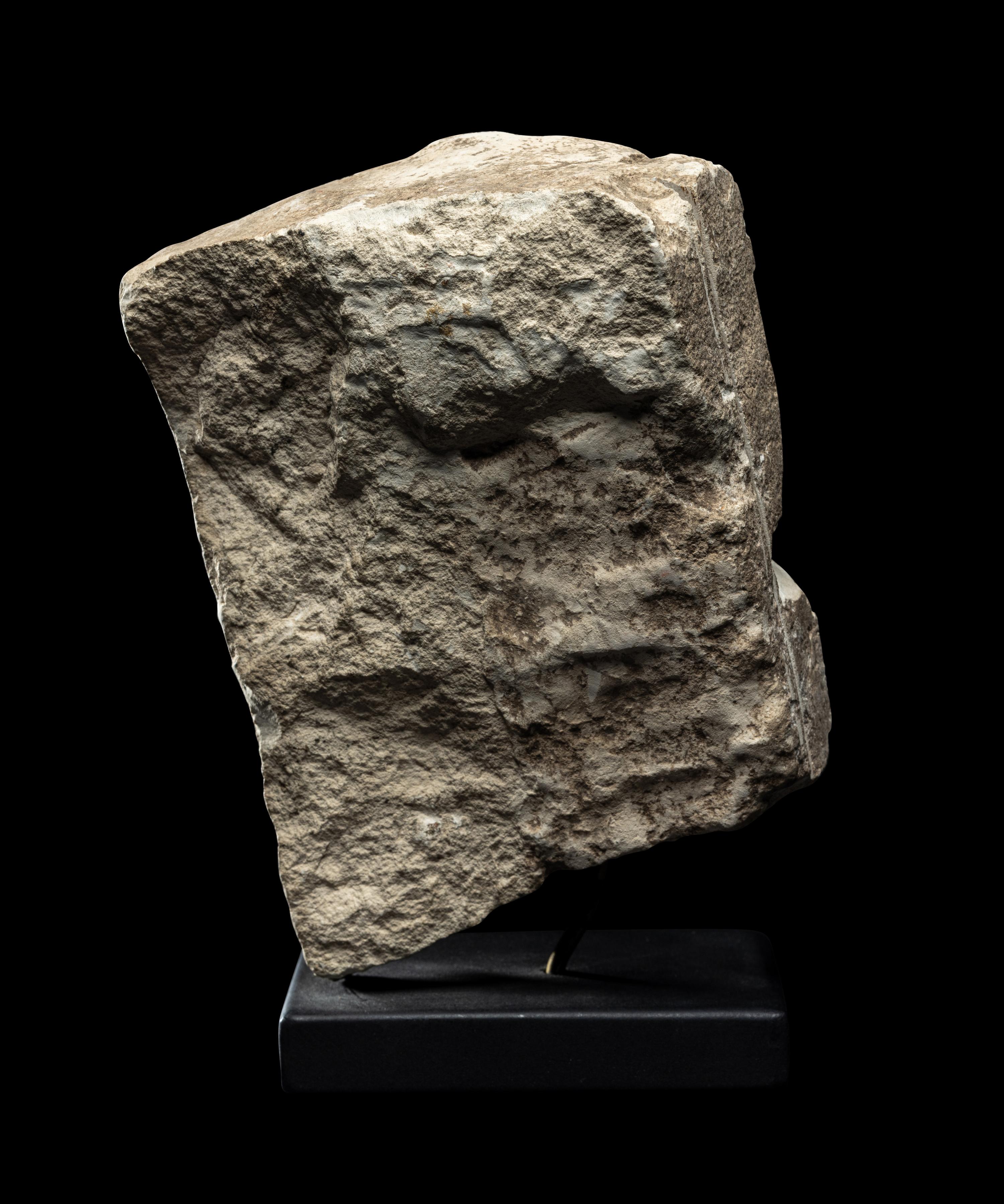 An Egyptian Limestone Fragment of a Mother Nursing her Child