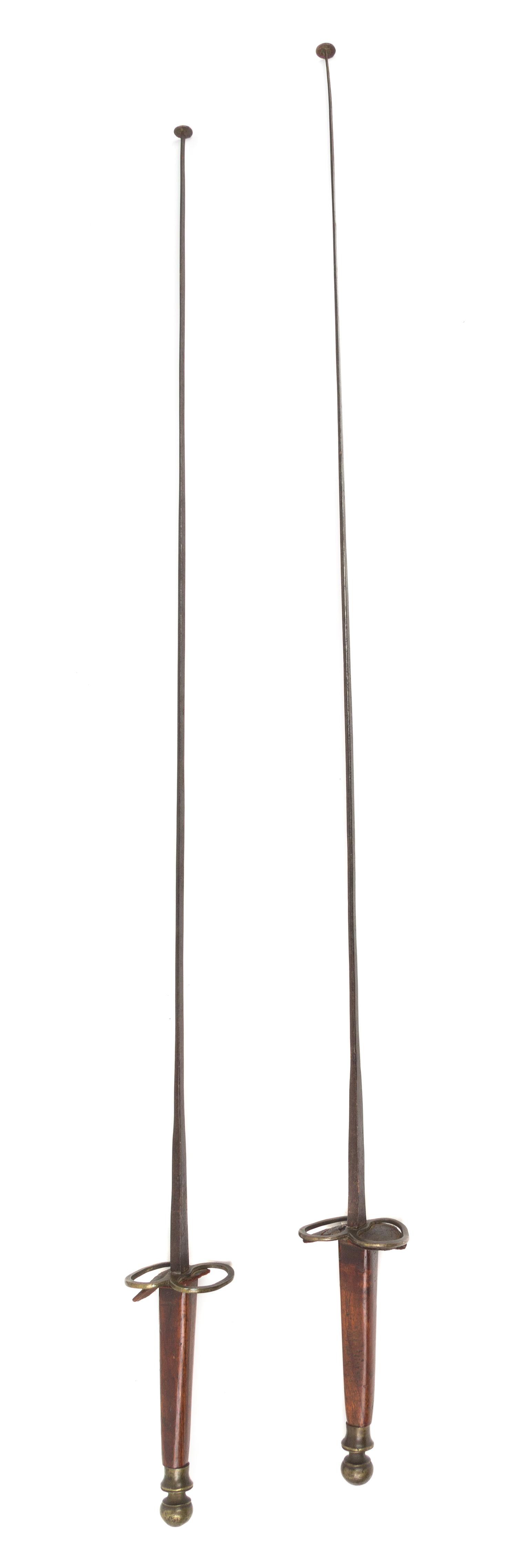 A Pair of Mahogany Handled Fencing Foils Length 39 1/2 inches.