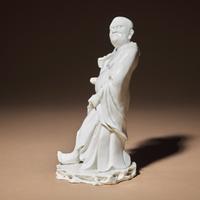 A Chinese Blanc-de-Chine Porcelain Standing Figure of a Luohan, Qing Dynasty — 清 德化白瓷羅漢立像