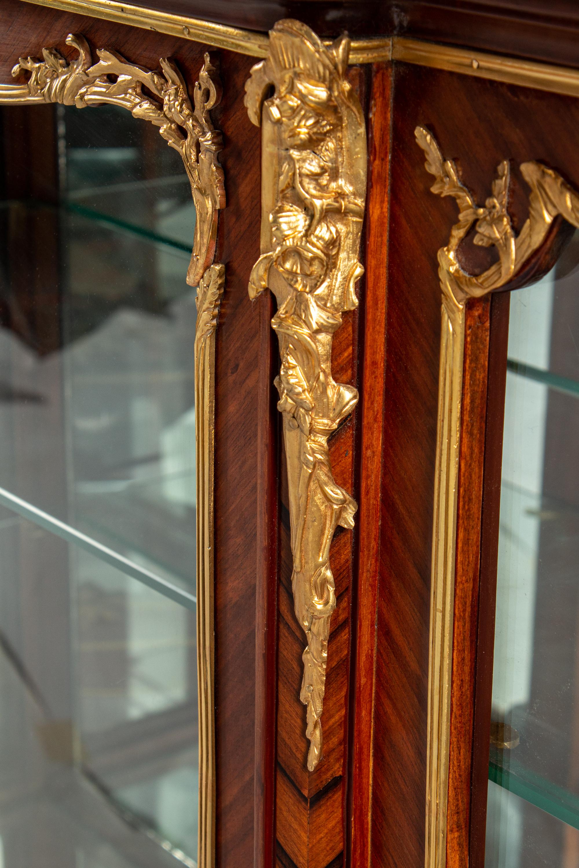 A Pair of Louis XV Style Gilt Bronze Mounted Kingwood and Rosewood Marble-Top Vitrine Cabinets