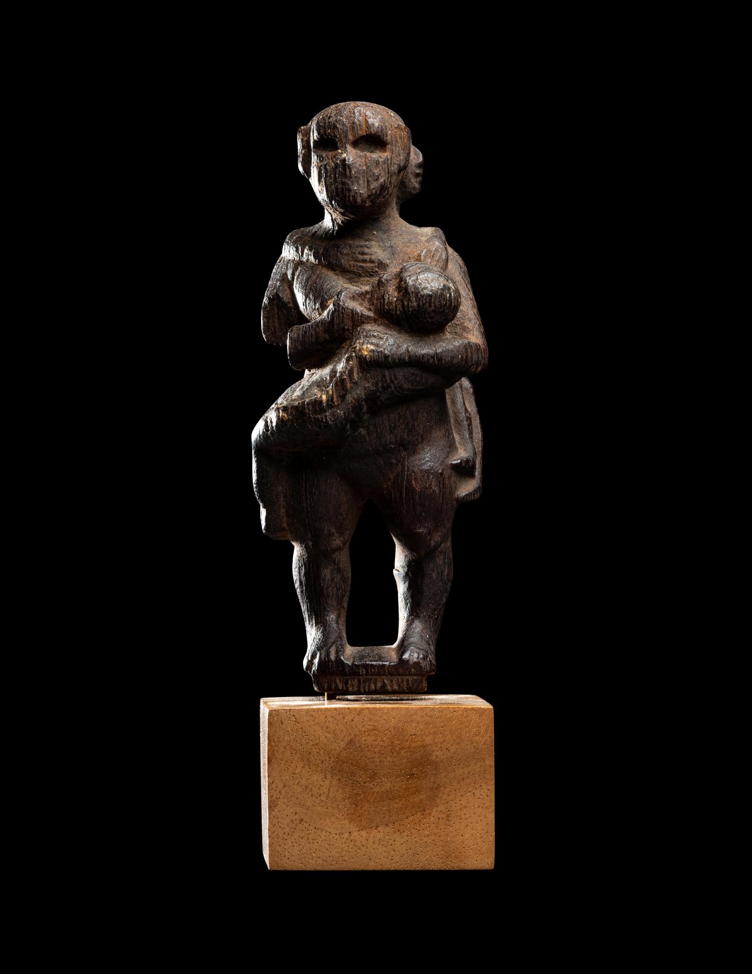 An Egyptian Wood Woman Holding Two Children