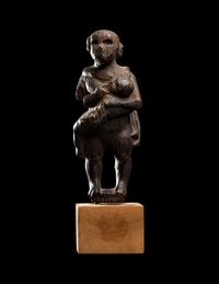 An Egyptian Wood Woman Holding Two Children