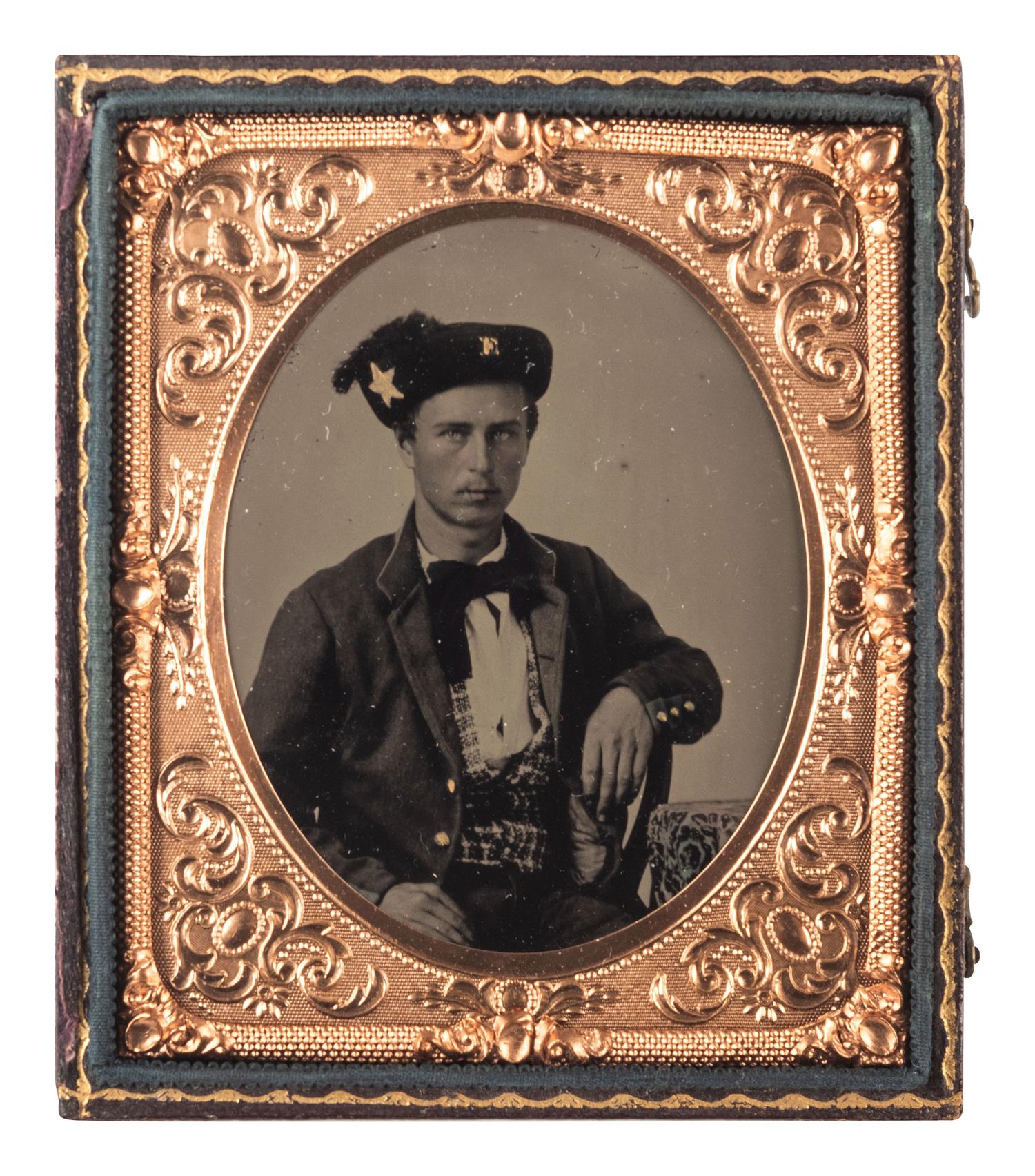 [CIVIL WAR]. Sixth plate tintype of a young soldier, possibly from New York, with a large star and "E" insignia on his cap.