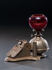 A Cast Iron Cigar Cutter with Lighter