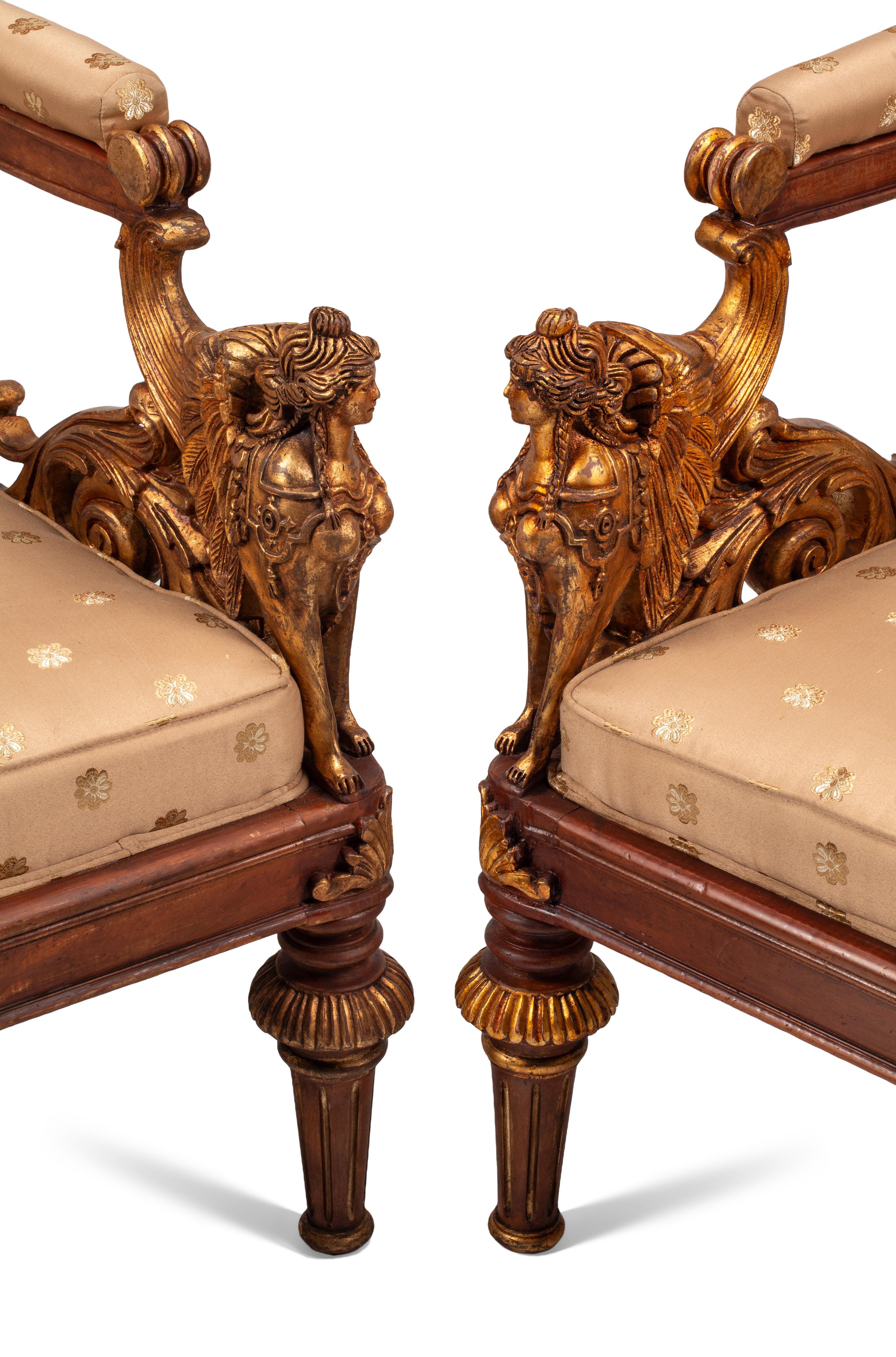 A Pair of Empire Style Parcel Gilt Walnut Armchairs