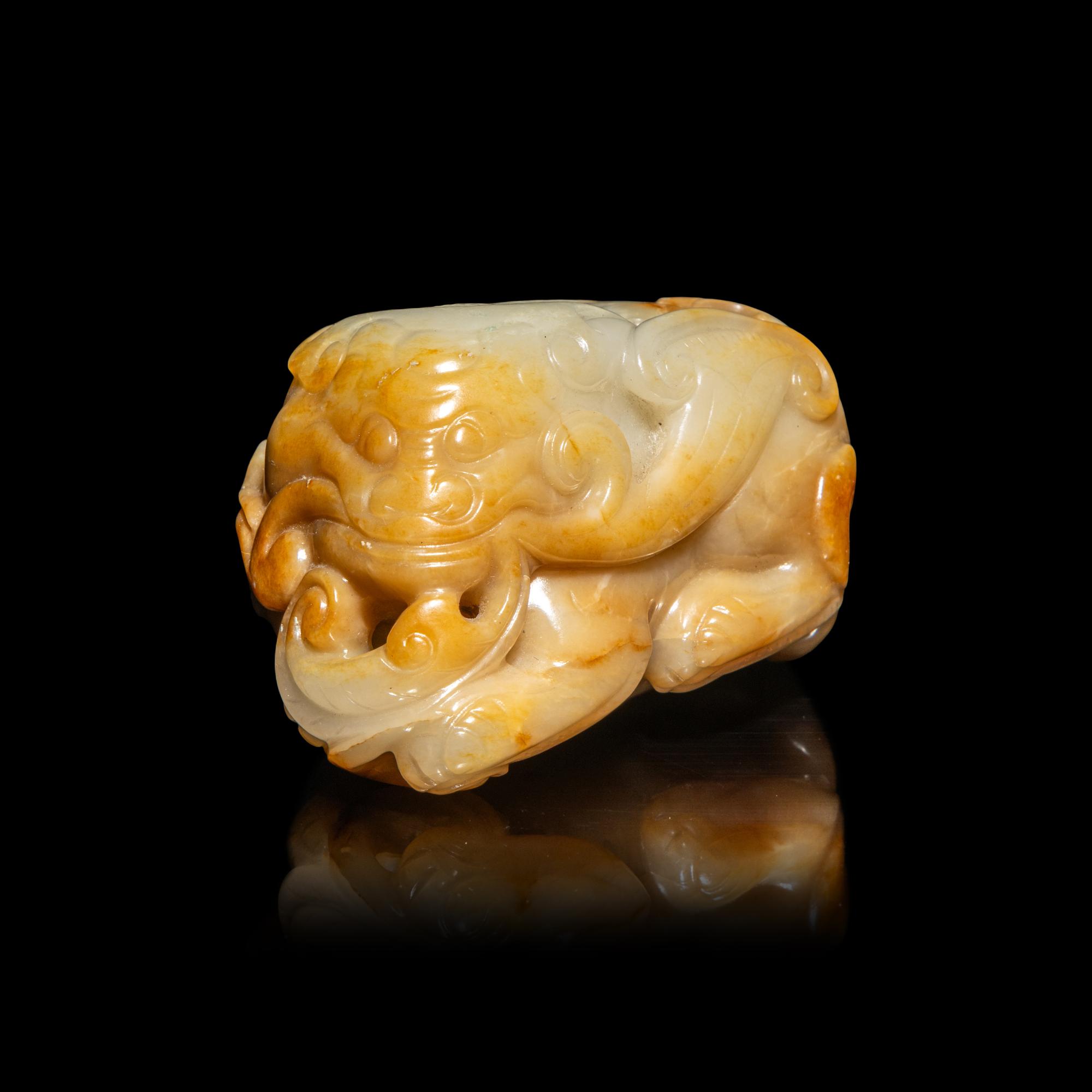 A Chinese White and Russet Jade Mythical Beast, Bixie, Ming Dynasty (1368-1644) 明 白玉辟邪