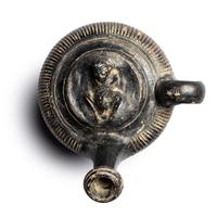 A Campanian Black-Glazed Guttus with a Grotesque