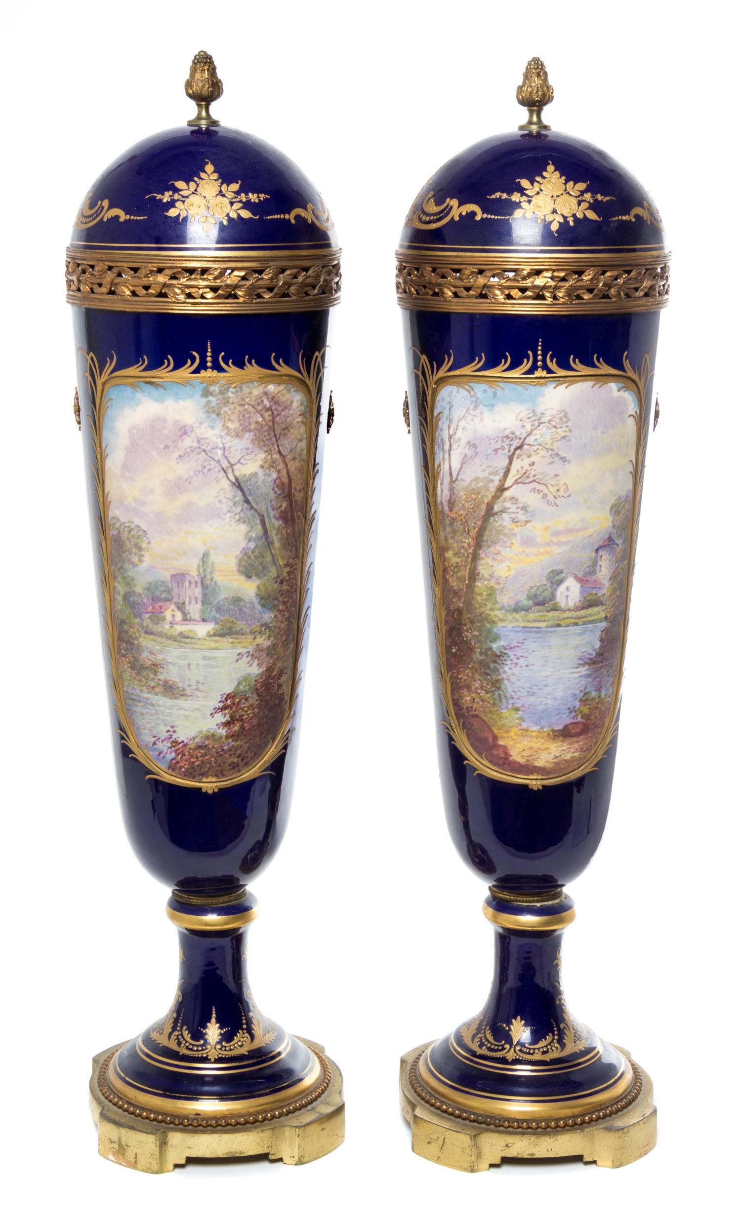 A Pair of Sevres Porcelain Lidded Urns Height 28 inches.