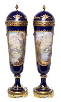 A Pair of Sevres Porcelain Lidded Urns Height 28 inches.